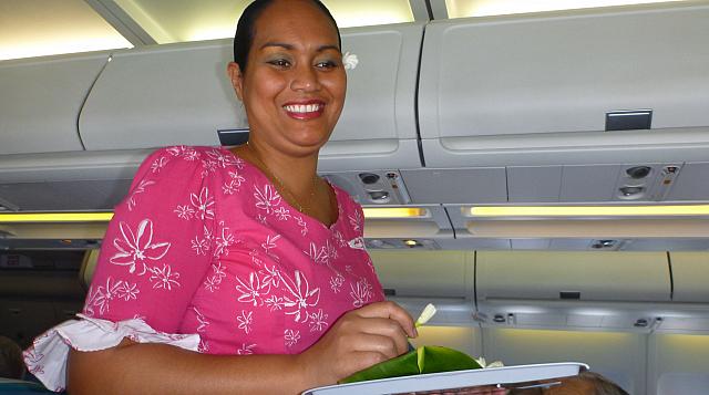 Flight attendant with fragrant tiare bud for each of us...right ear = available; left ear = 'taken'