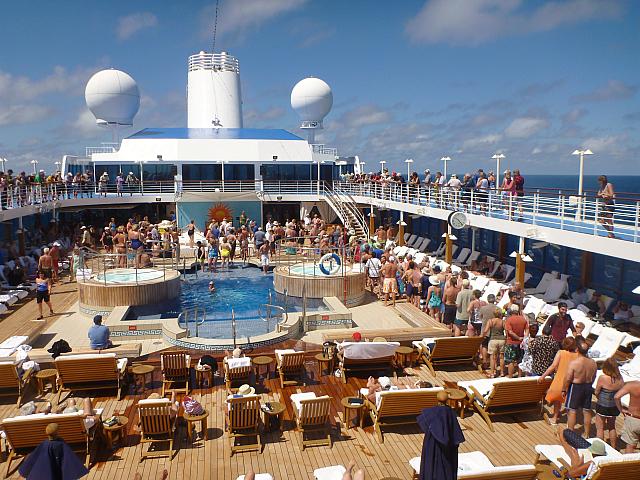 'Pollywogs' (those who have not previously crossed the Equator) wait in line to kiss the fish and bow before King Neptune, thus becoming "Shellbacks"
