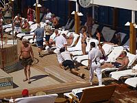 Member of the staff is brought before King Neptune for his 'punishment'